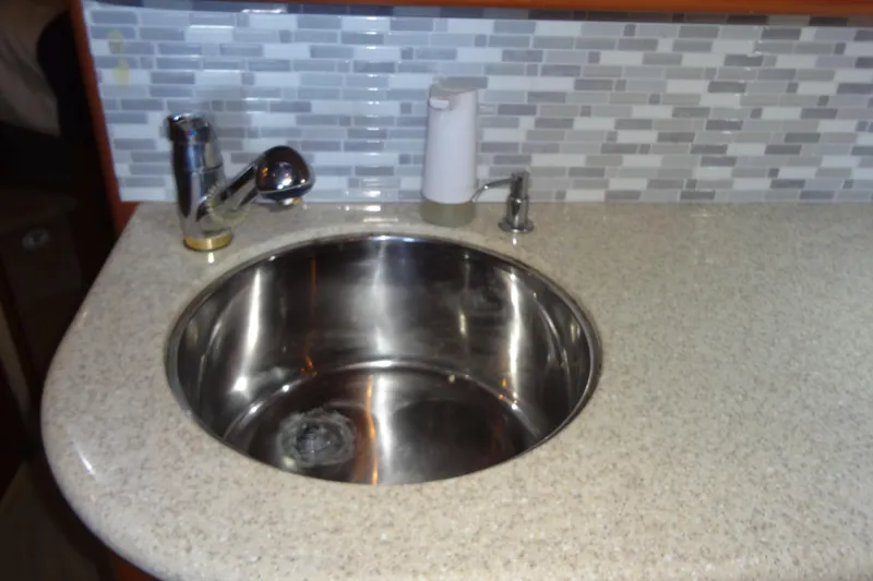 Slide: The Image of Stainless steel sink in 2005 Silverton 34 Convertible yacht kitchen with tiled backsplash. - 44