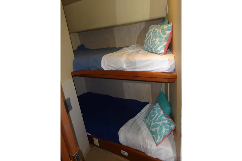 Slide: The Image of Bunk beds in 2005 Silverton 34 Convertible yacht cabin with colorful pillows. - 45