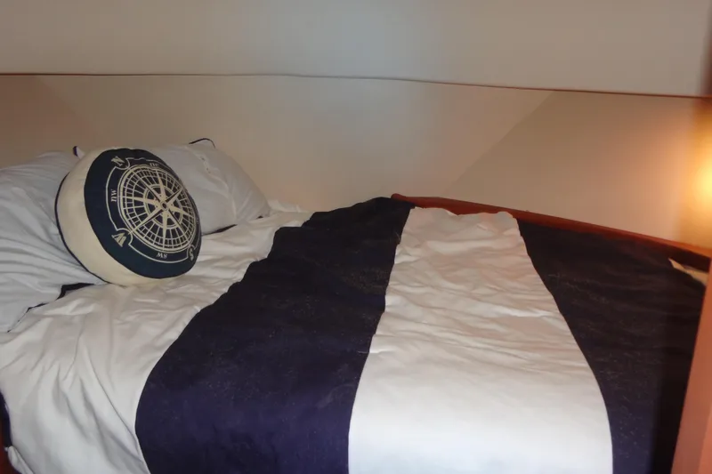 Slide: The Image of Cozy cabin bed in 2005 Silverton 34 Convertible yacht with nautical-themed pillow. - 46