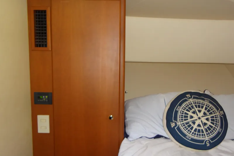 Slide: The Image of Interior of 2005 Silverton 34 Convertible with nautical-themed pillow and wooden paneling. - 48