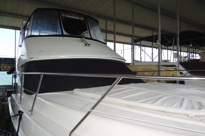 Slide: The Image of 2005 Silverton 34 Convertible yacht docked under a covered marina. - 5