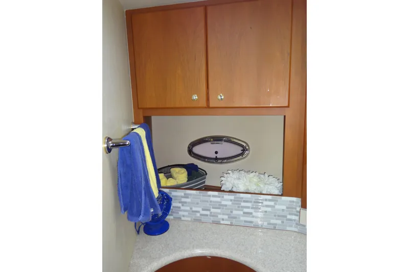 Slide: The Image of 2005 Silverton 34 Convertible bathroom with wooden cabinets and decorative accents. - 50
