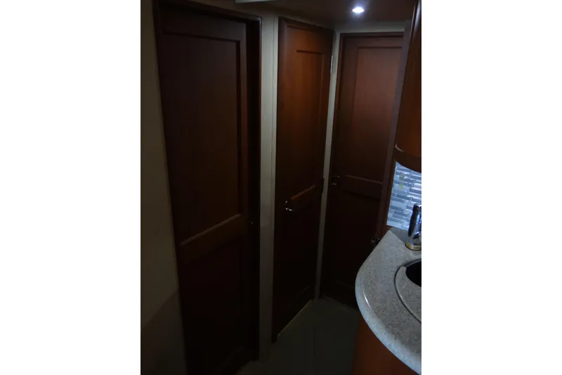 Slide: The Image of Interior view of 2005 Silverton 34 Convertible yacht with wooden doors and countertop. - 53