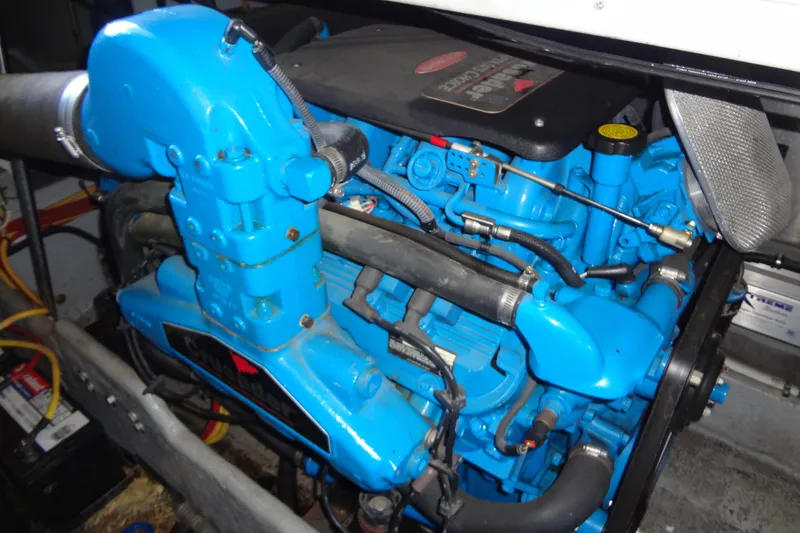 Slide: The Image of Engine of a 2005 Silverton 34 Convertible boat, featuring vibrant blue components. - 54