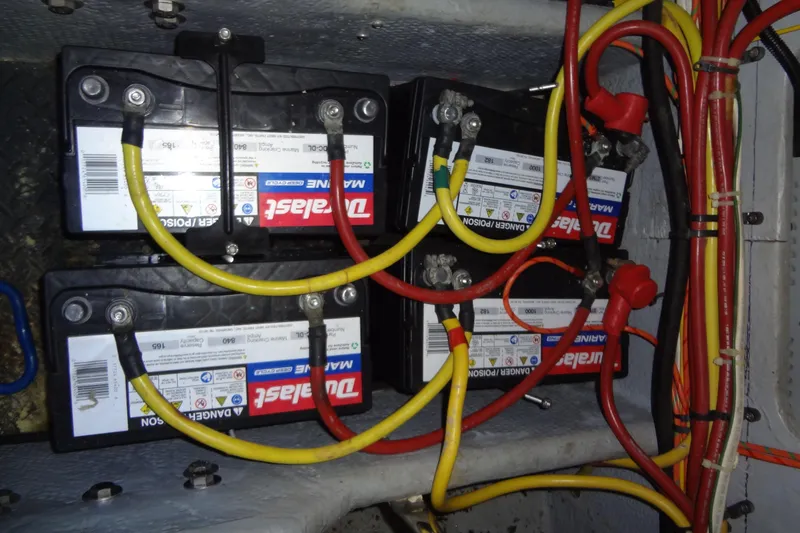 Slide: The Image of Battery setup in a 2005 Silverton 34 Convertible boat engine compartment. - 57