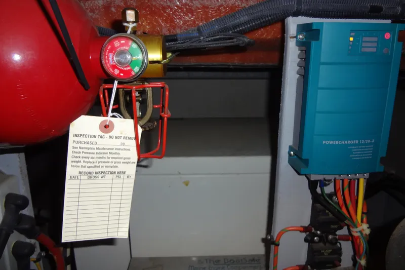 Slide: The Image of Engine room of 2005 Silverton 34 Convertible with fire extinguisher and power charger. - 58