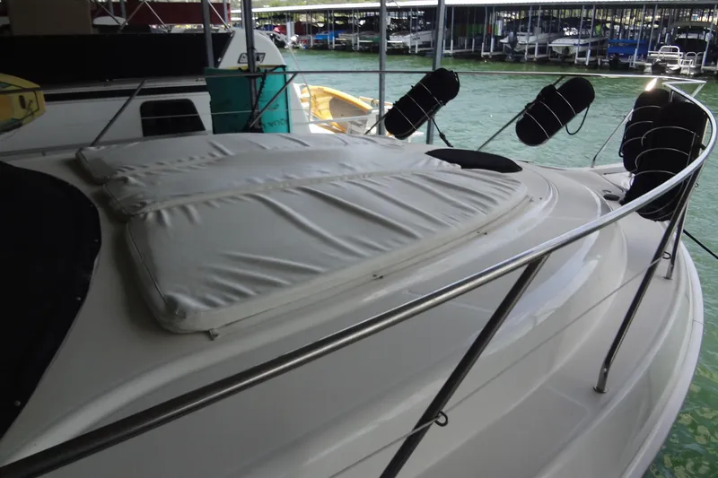 Slide: The Image of 2005 Silverton 34 Convertible yacht with cushioned deck, docked at marina. - 7
