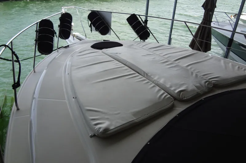 Slide: The Image of 2005 Silverton 34 Convertible yacht deck with cushioned seating and water view. - 9