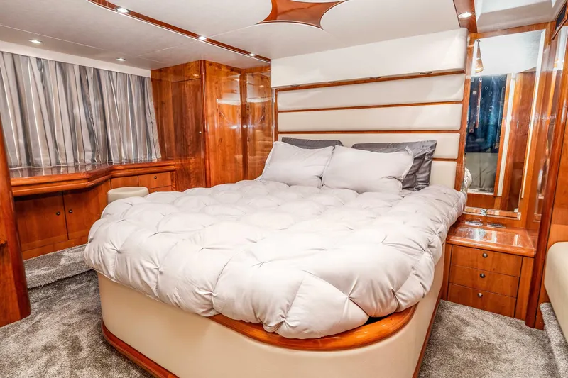 Slide: The Image of Luxurious bedroom interior of 2005 Sunseeker Predator 68 yacht with plush bedding and wood accents. - 12
