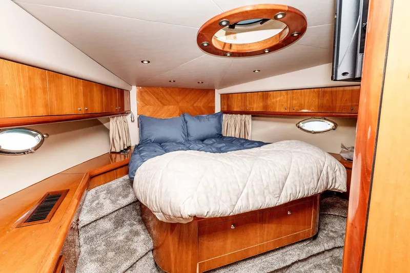 Slide: The Image of Luxurious cabin interior of 2005 Sunseeker Predator 68 yacht with cozy bed and wood finish. - 13