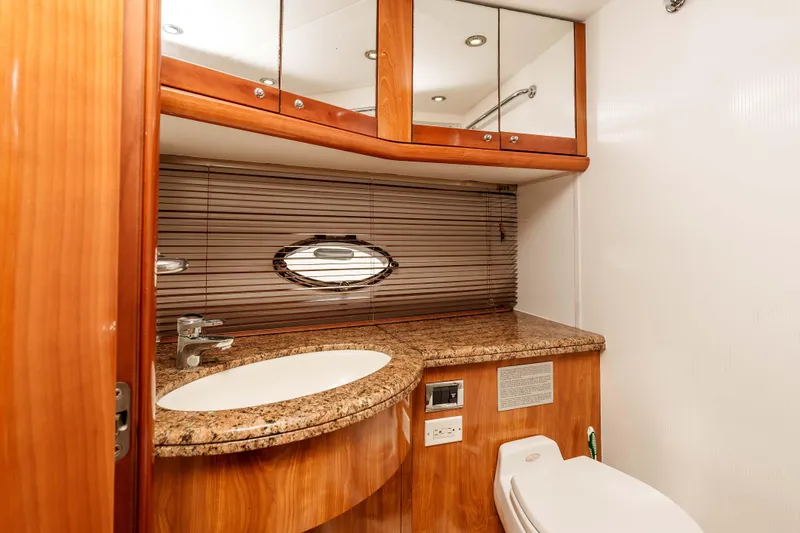 Slide: The Image of Luxurious bathroom in 2005 Sunseeker Predator 68 yacht with wood cabinetry and granite countertop. - 34