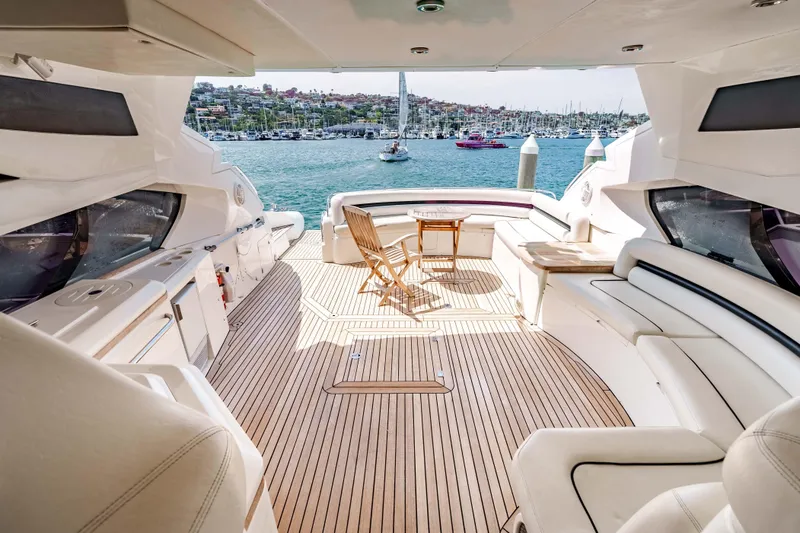 Slide: The Image of Luxurious 2005 Sunseeker Predator 68 yacht interior with elegant seating and scenic marina view. - 3