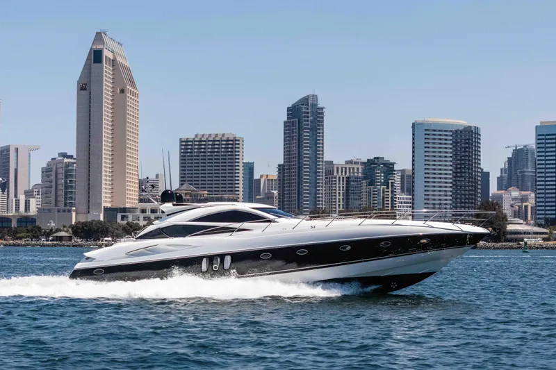 The Image of 2005 Sunseeker Predator 68 yacht cruising near city skyline on a sunny day. - 0