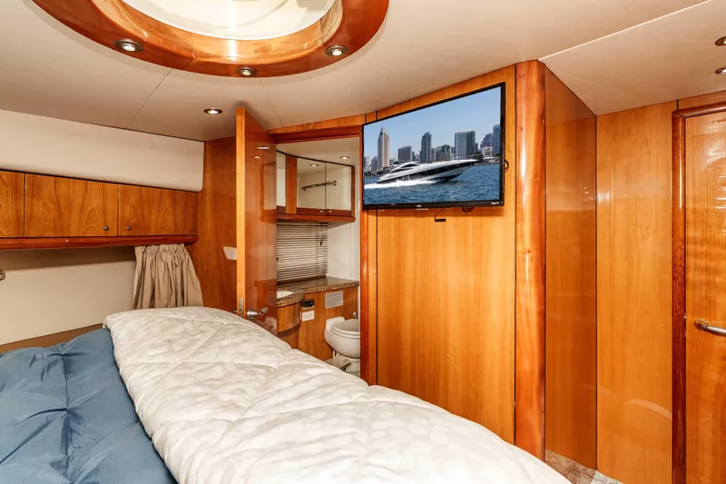 Slide: The Image of Luxurious cabin interior of 2005 Sunseeker Predator 68 yacht with wood paneling and TV. - 33
