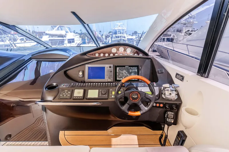 Slide: The Image of Helm of 2005 Sunseeker Predator 68 yacht with advanced navigation controls and steering wheel. - 5