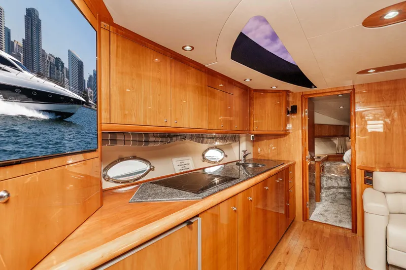 Slide: The Image of Luxurious interior of 2005 Sunseeker Predator 68 yacht with sleek wood finishes and modern amenities. - 23