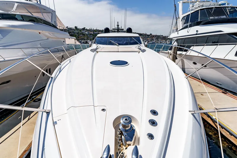 Slide: The Image of 2005 Sunseeker Predator 68 yacht docked between two boats. - 6