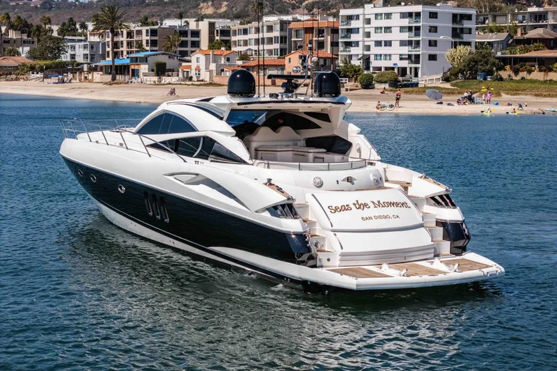 Slide: The Image of Luxury 2005 Sunseeker Predator 68 yacht cruising near a scenic coastal area. - 7