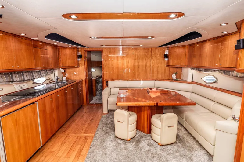 Slide: The Image of Luxurious interior of 2005 Sunseeker Predator 68 yacht with elegant wood finishes and plush seating. - 8