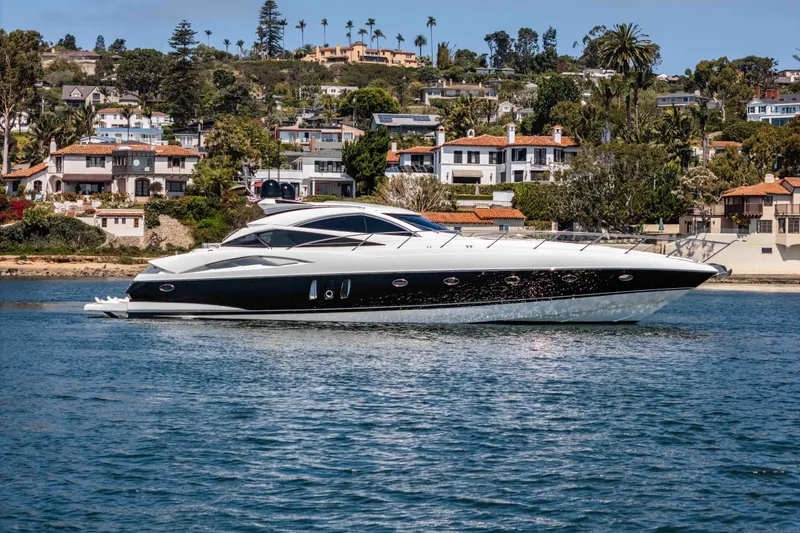 Slide: The Image of Luxury Sunseeker Predator 68 yacht cruising near coastal homes, 2005 model. - 1