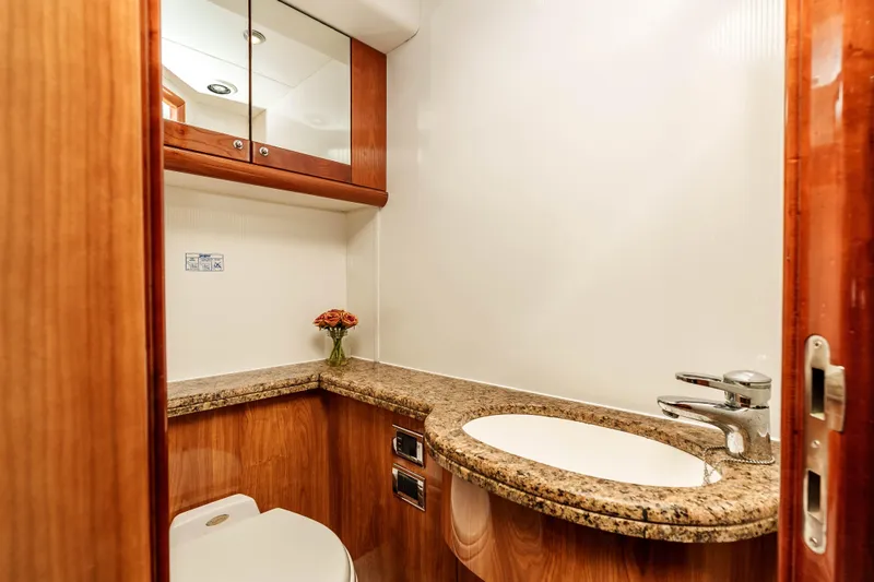 Slide: The Image of Luxurious bathroom in 2005 Sunseeker Predator 68 yacht with granite countertop and wooden cabinetry. - 21