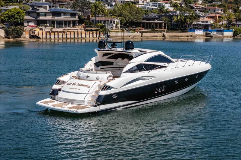 Slide: The Image of 2005 Sunseeker Predator 68 yacht cruising in a scenic waterfront area. - 9
