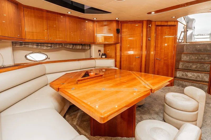 Slide: The Image of Luxurious interior of 2005 Sunseeker Predator 68 yacht with elegant wood finishes and plush seating. - 19