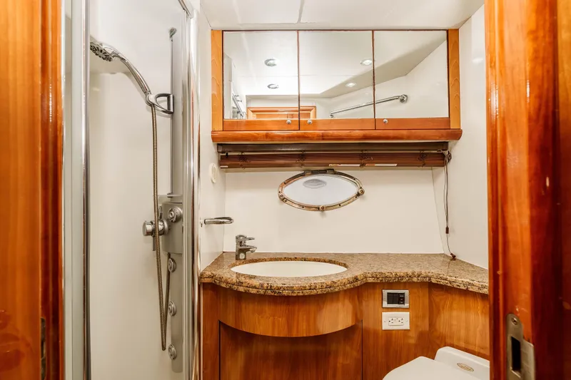 Slide: The Image of Luxurious bathroom in 2005 Sunseeker Predator 68 yacht with wood accents and modern fixtures. - 29