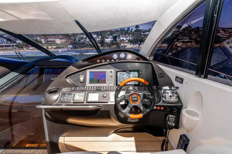 Slide: The Image of Cockpit of 2005 Sunseeker Predator 68 yacht with advanced navigation controls and steering wheel. - 15