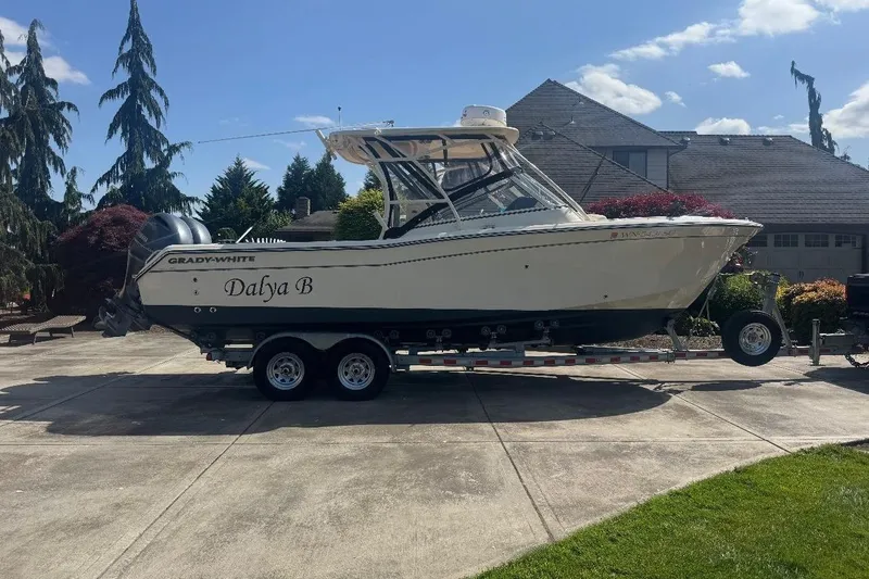 The Image of 2020 Grady-White 275 Freedom boat on trailer in residential driveway. - 1