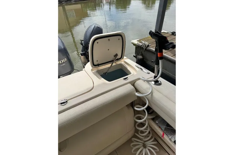 Slide: The Image of 2020 Grady White 275 Freedom boat with open storage compartment and coiled hose on deck. - 10