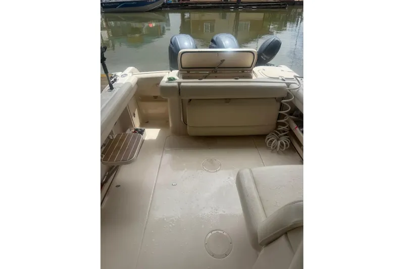Slide: The Image of 2020 Grady White 275 Freedom boat interior with dual engines, docked on calm water. - 11