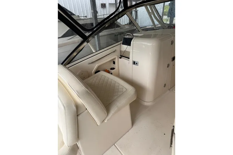 Slide: The Image of Interior of 2020 Grady White 275 Freedom boat with beige seating and dashboard. - 22