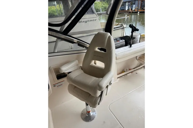 Slide: The Image of Captain's chair on 2020 Grady White 275 Freedom boat, docked by the water. - 3