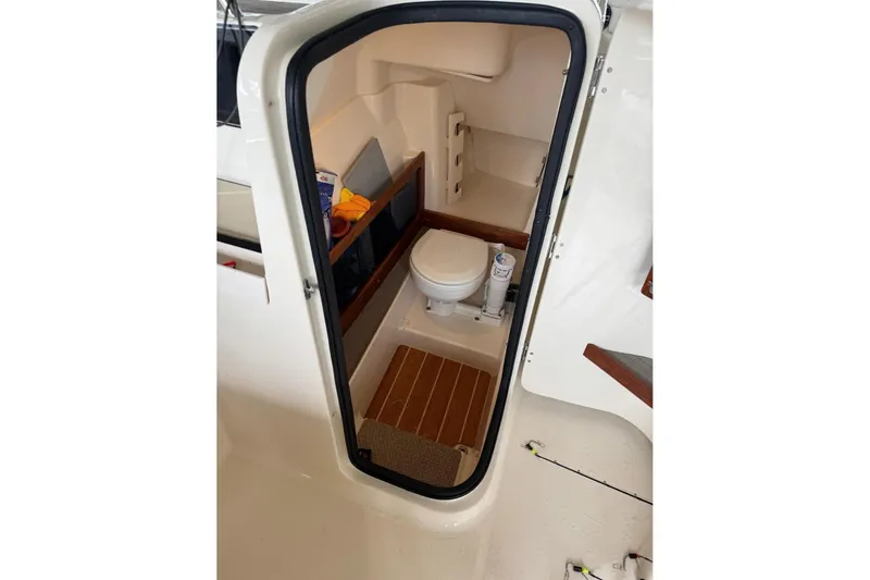 Slide: The Image of 2020 Grady White 275 Freedom boat interior with compact marine toilet. - 5