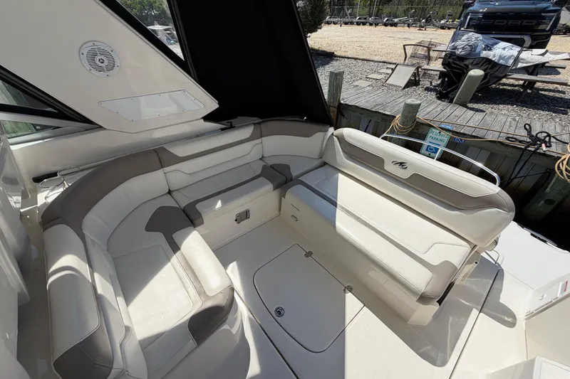 Slide: The Image of Luxurious seating area on a 2009 Monterey 340 Sport Yacht, docked near a wooden pier. - 19