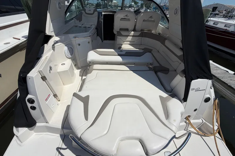 Slide: The Image of 2009 Monterey 340 Sport Yacht interior with white seating and sleek design. - 17