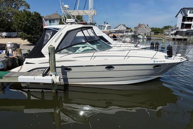 Slide: The Image of 2009 Monterey 340 Sport Yacht docked in a marina, showcasing sleek design and modern features. - 8