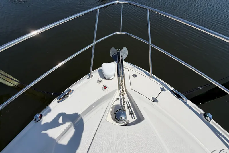 Slide: The Image of Bow of 2009 Monterey 340 Sport Yacht with anchor and railing on calm water. - 43