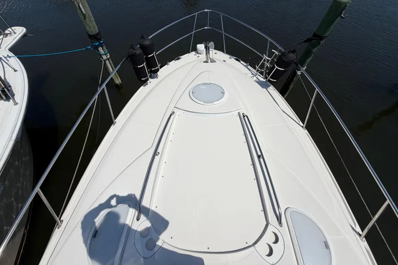 Slide: The Image of Bow view of a 2009 Monterey 340 Sport Yacht docked at a marina. - 42