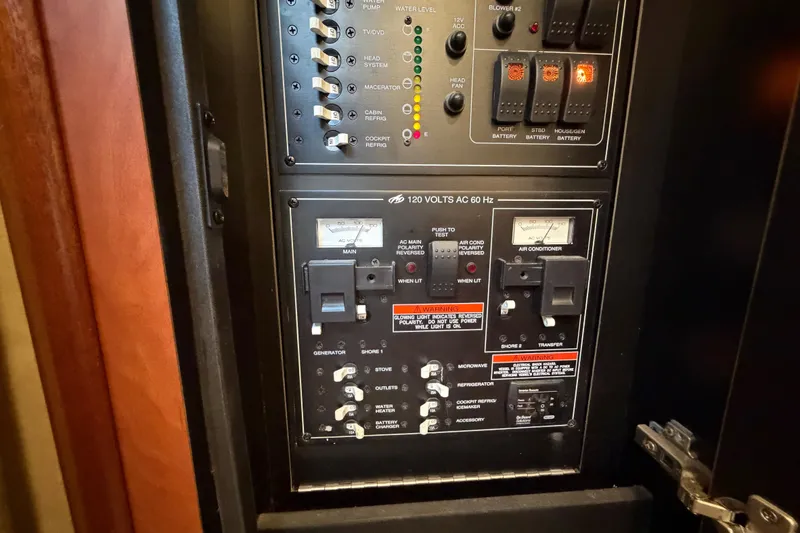 Slide: The Image of Electrical control panel on a 2009 Monterey 340 Sport Yacht, featuring switches and indicators. - 47