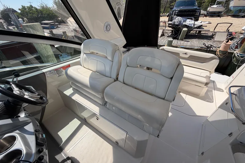 Slide: The Image of 2009 Monterey 340 Sport Yacht interior with plush seating and modern helm controls. - 23