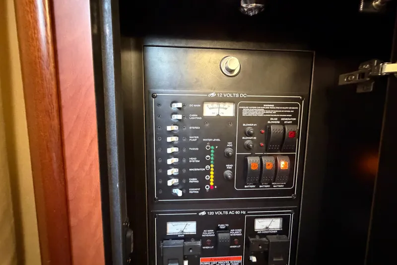 Slide: The Image of Electrical control panel on a 2009 Monterey 340 Sport Yacht, featuring switches and indicators. - 46