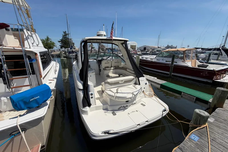 Slide: The Image of 2009 Monterey 340 Sport Yacht docked at marina under clear blue sky. - 39