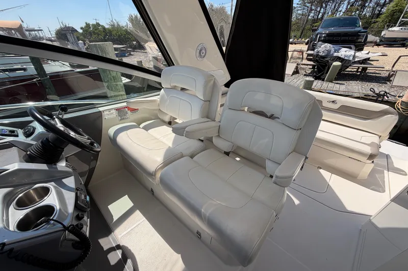Slide: The Image of 2009 Monterey 340 Sport Yacht interior with white seating and steering wheel. - 24
