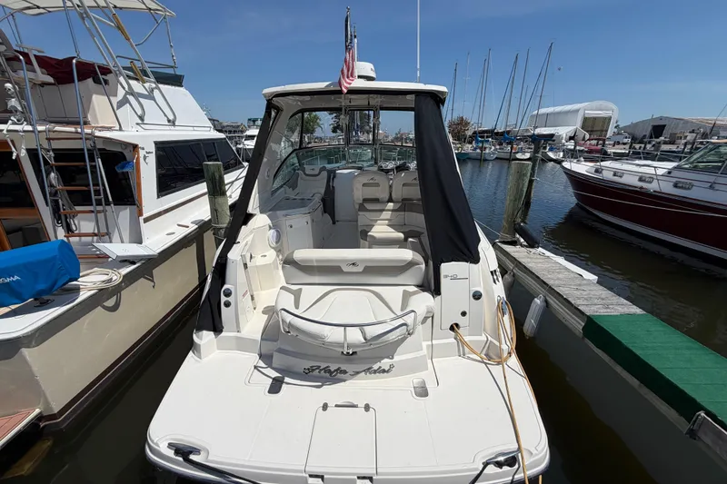 Slide: The Image of 2009 Monterey 340 Sport Yacht docked at marina, surrounded by other boats. - 37