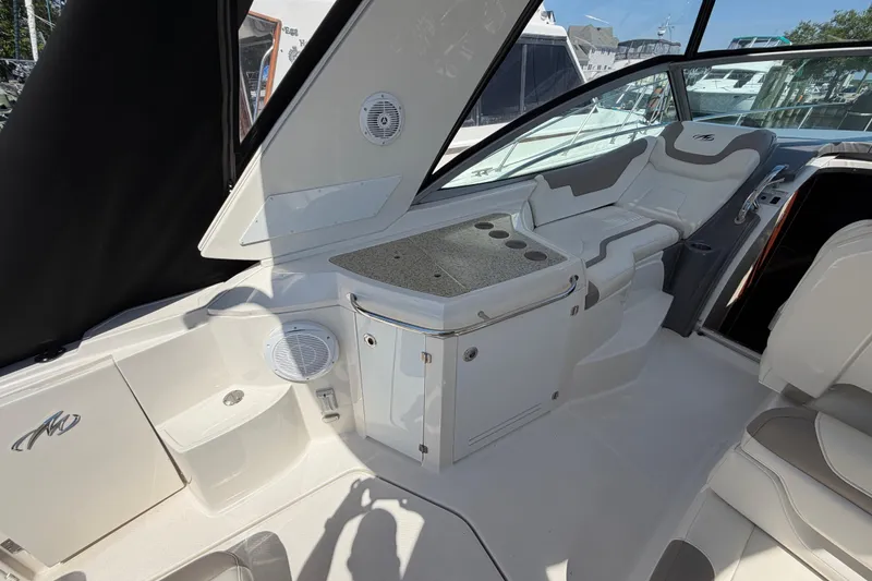 Slide: The Image of 2009 Monterey 340 Sport Yacht interior with seating and storage, featuring sleek design elements. - 20