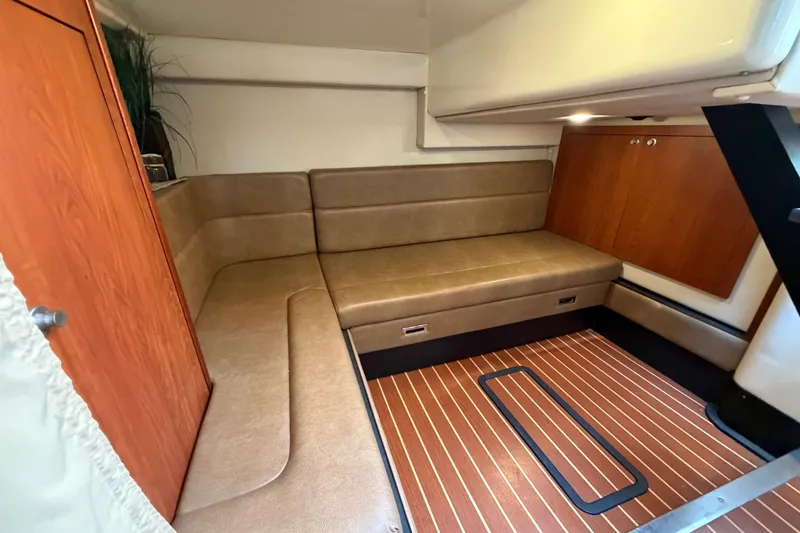Slide: The Image of Interior of 2009 Monterey 340 Sport Yacht with beige seating and wooden flooring. - 35