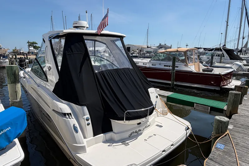 Slide: The Image of 2009 Monterey 340 Sport Yacht docked at marina, featuring sleek design and black canopy. - 12