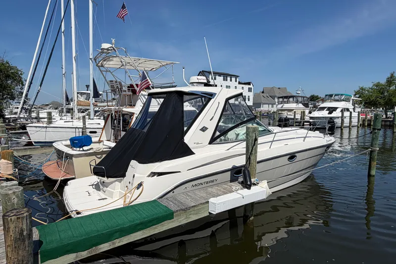 Slide: The Image of 2009 Monterey 340 Sport Yacht docked at a marina, surrounded by other boats. - 10